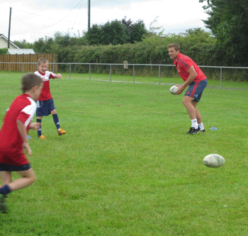 CJ Stander passes to his teammate at the Newcastlewest Summer Camp